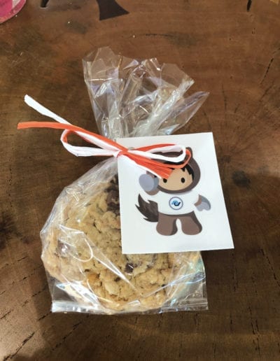 chocolate chip cookie wrapped in cellophane with Salesforce sticker on top